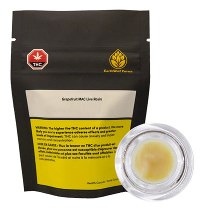 Front-facing shot of a black pouch and clear jar of Grapefruit Mac Live Rosin by EarthWolf Farms, the pouch showing warning labels and a gold logo.
