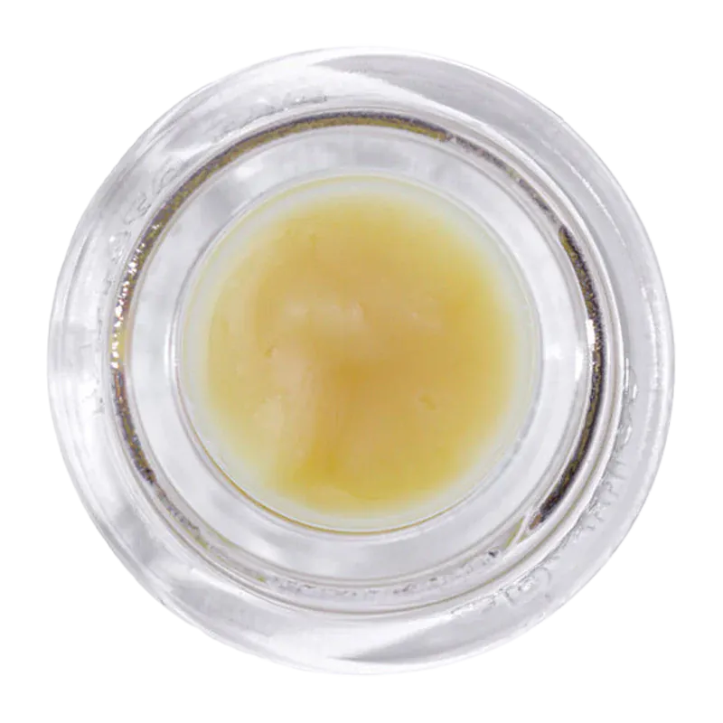 Top-down view of a small jar of Grapefruit Mac Live Rosin showing its pale yellow, creamy concentrate against a white background.
