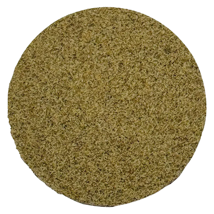 Top-down view of a dense, light-brown puck of Dry Sift Press Hash filling the circular frame.