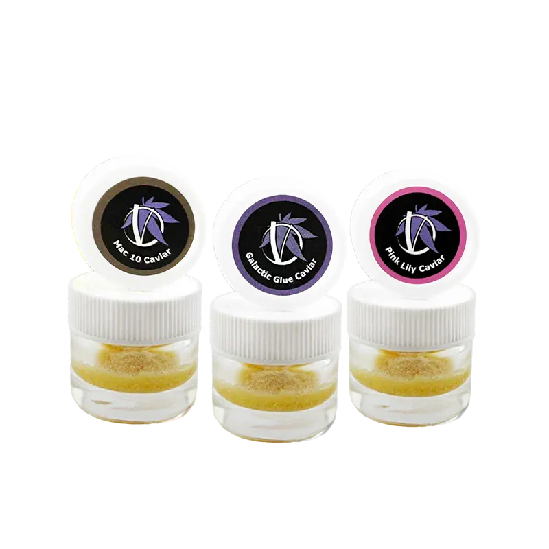 Three small clear jars photographed front-on with white lids and colored logo stickers, labeled Virtue Caviar Flight Caviar.