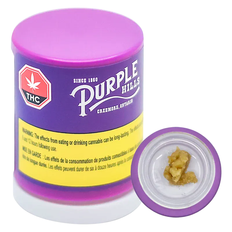Front-angle photo of a purple container labeled "Purple Hills" with its lid off showing a dab of Tropical Twist Live Resin Badder in a small white dish.
