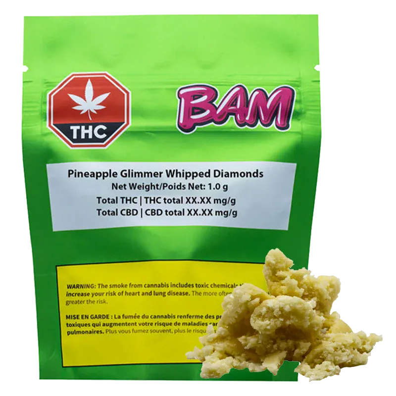 Front-facing shot of a green pouch labeled "Pineapple Glimmer Whipped Diamonds" with a pink "BAM" logo and a crumbly pale concentrate heap in the foreground.