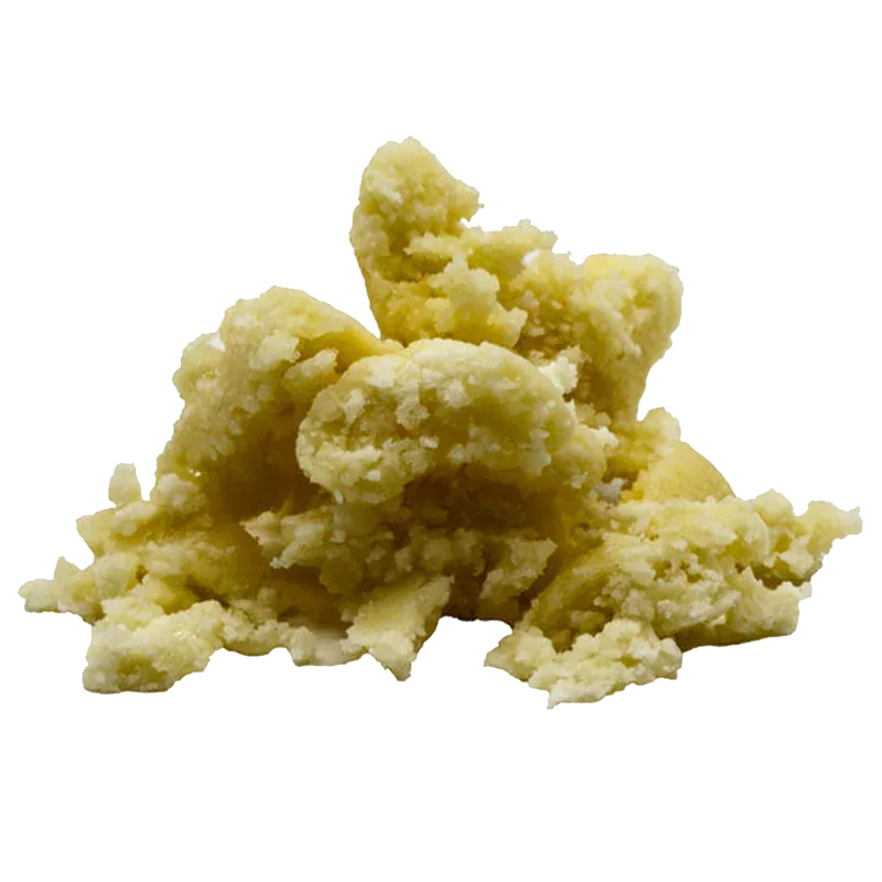 Close-up of a pale yellow crumbly mound on white background, labeled in context as Pineapple Glimmer Whipped Diamonds.