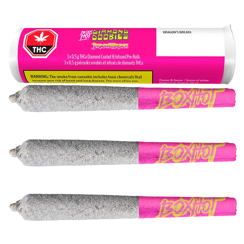 Three horizontal Diamond Doobies Dragon's Breath Infused PR 3 x 0.5 g pre-rolls coated in a sparkly silver layer with pink "BoxHot" tips beneath their matching pink cylindrical packaging.