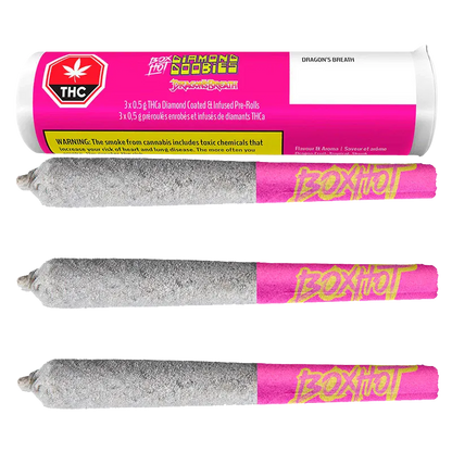 Three horizontal Diamond Doobies Dragon's Breath Infused PR 3 x 0.5 g pre-rolls coated in a sparkly silver layer with pink "BoxHot" tips beneath their matching pink cylindrical packaging.