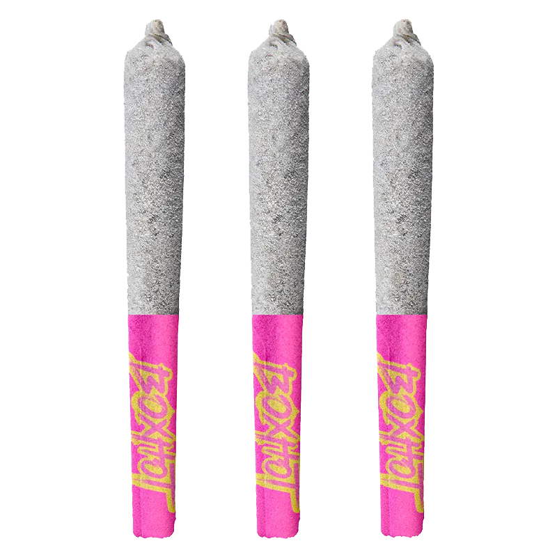 Three upright Dragon's Breath Infused PR 3 x 0.5 g pre-rolls with ash-tipped gray cones and bright pink Diamond Doobies branded tips.