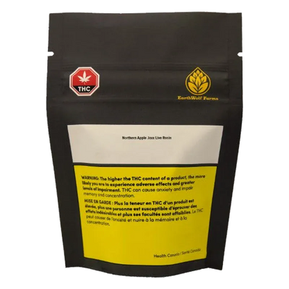 Rear view of a black pouch labeled Northern Apple Jaxx Live Rosin with a white top panel, yellow warning box, and small THC and EarthWolf Farms logos.