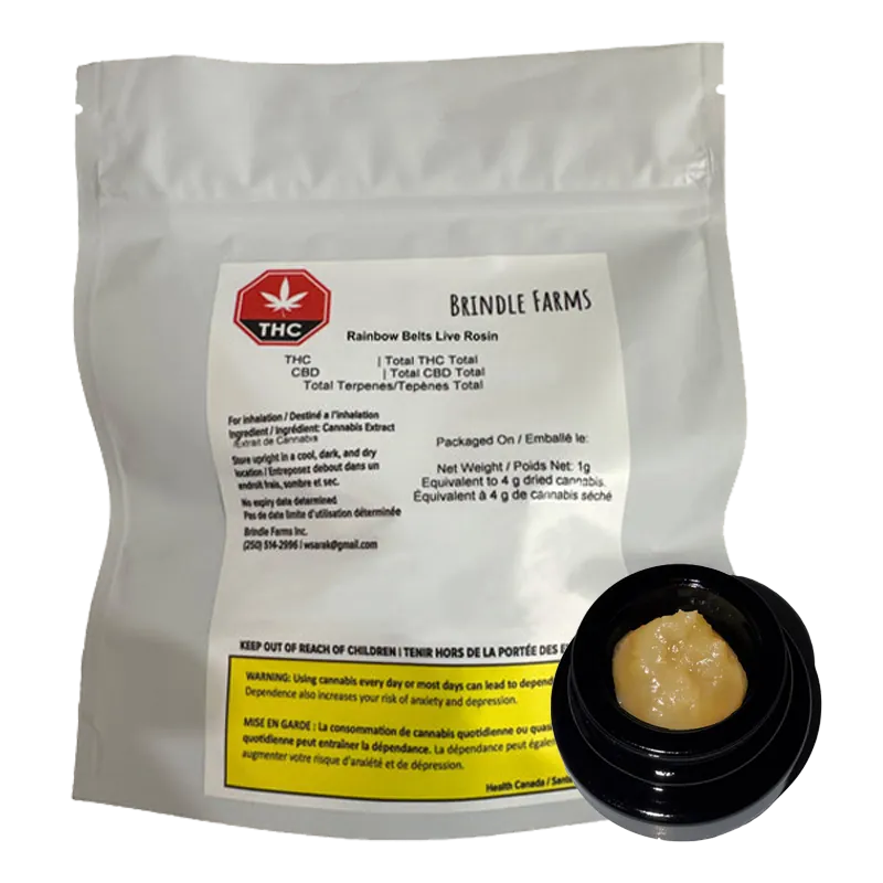 White pouch standing upright with a label and a small open black jar of pale yellow concentrate in front, showing "Rainbow Belts Live Rosin" by Brindle Farms.