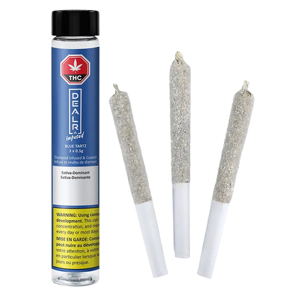 Three pre-rolled joints coated in crystalline sugar beside a standing blue tube labeled "Blue Tartz Infused PR 3 x 0.5 g."