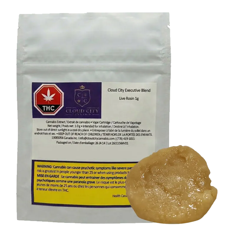 Front-facing shot of a white pouch and amber dab showing the 2026 Executive Blend Live Rosin label and glossy extract in the lower right.