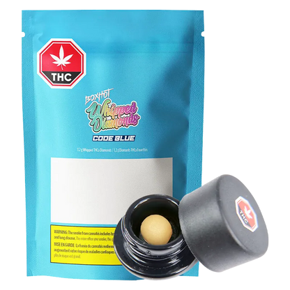 Front-facing shot of a blue pouch and open jar showing a beige ball concentrate, labeled Code Blue Whipped Diamonds.