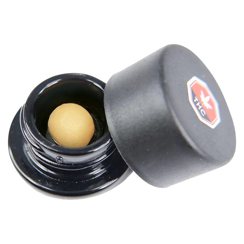 Close angled view of an open black jar revealing a smooth tan sphere inside, labeled as Code Blue Whipped Diamonds.