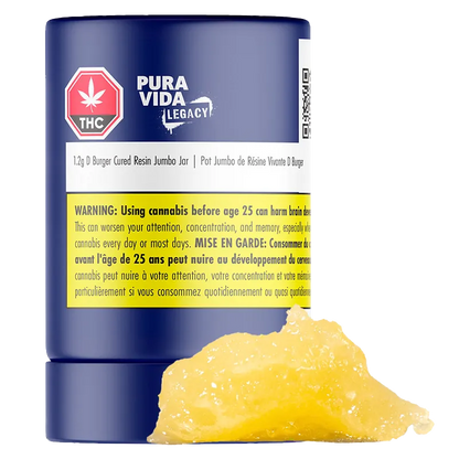 Close-up front view of a blue jar labeled "Pura Vida Legacy D Burger Cured Resin Jumbo Jar" with a yellow warning label and a dollop of golden resin in front.