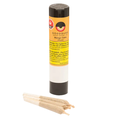Straight-on view of a standing tube labeled "Mango Cake Hash-Infused PR 3 x 0.5 g" with three rolled joints lying in front on a white background.