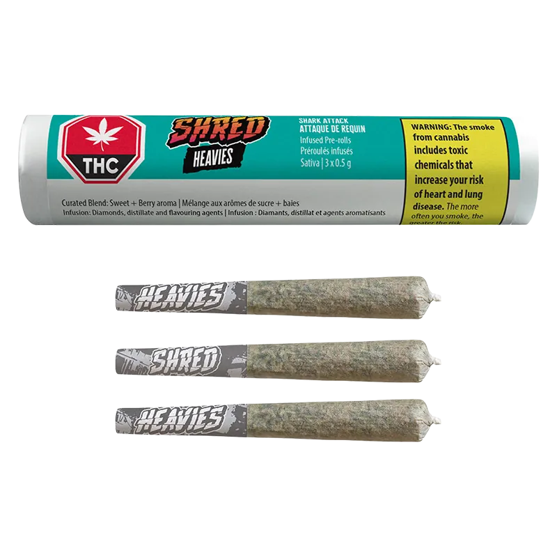 Top-down view of three rolled joints with gray "HEAVIES" tips beneath a turquoise tube labeled Shark Attack Heavies Infused PR 3 x 0.5 g.