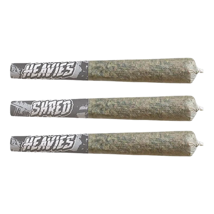 Three horizontal pre-rolled joints with gray "Heavies" paper tips shown in a flat lay of the Shark Attack Heavies Infused PR 3 x 0.5 g.