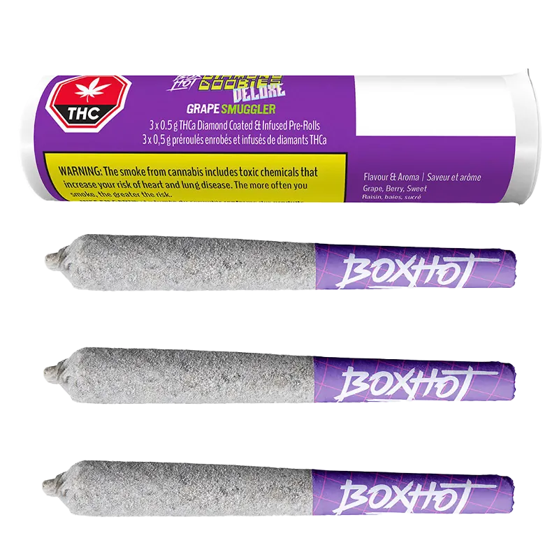Top-down view of the Grape Smuggler Infused PR 3 x 0.5 g tube label above three diamond-coated, ash-gray pre-rolls with purple "BOXHOT" tips.