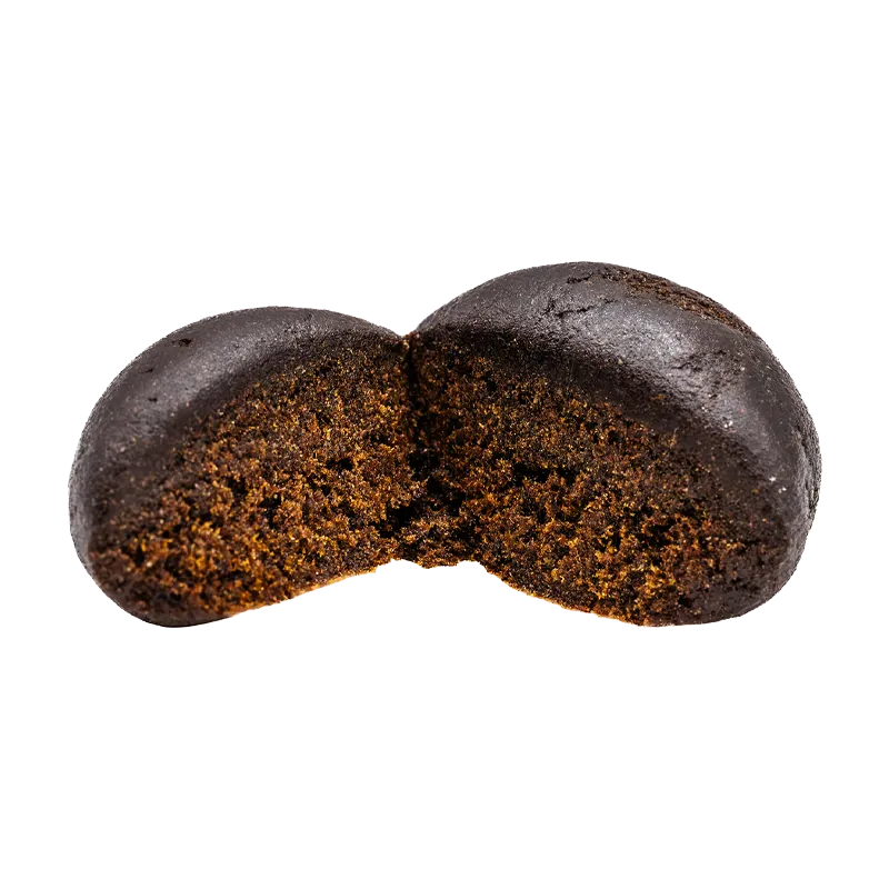 Close-up front view of a dark, broken chocolatey disc revealing a dense, crumbly interior labeled "Black Hash".