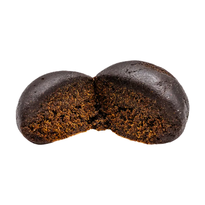 Close-up front view of a dark, broken chocolatey disc revealing a dense, crumbly interior labeled "Black Hash".