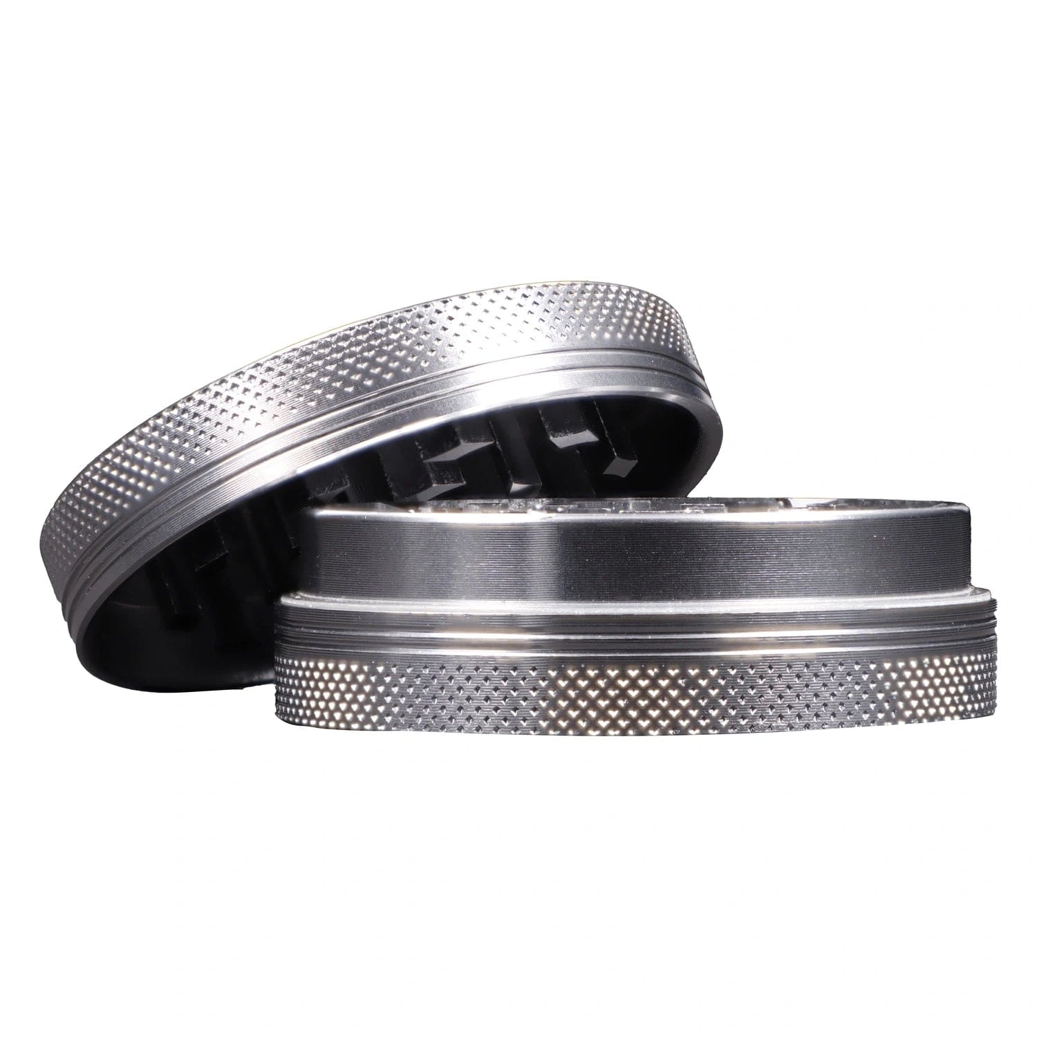 A top-down view of the open, two-piece Famous X - Crystal 2 pc Grinder in silver, showcasing its internal grinding teeth.