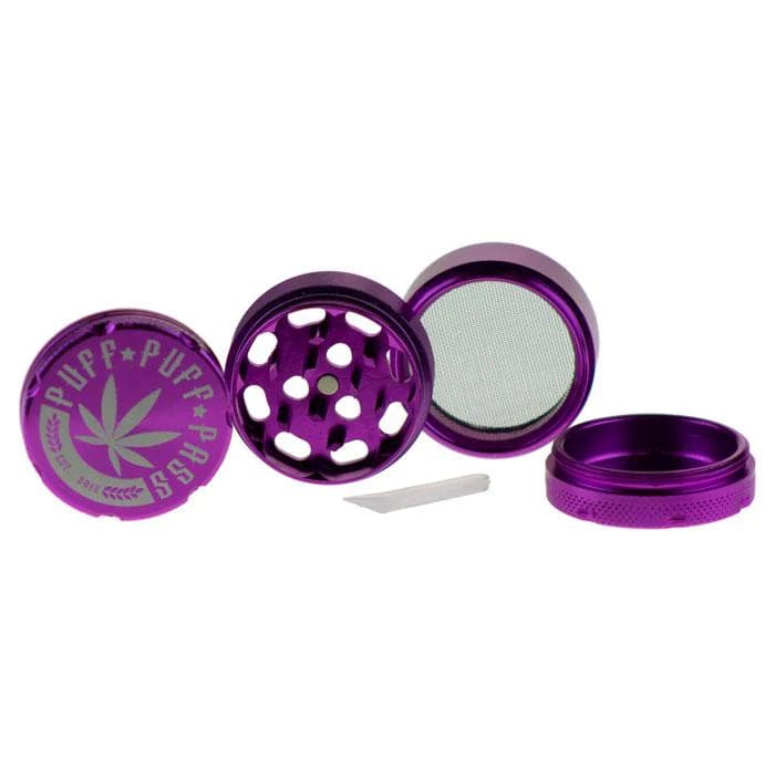 A top-down view of the open Puff Puff Pass Aluminum 4pc Grinder in purple, displaying its four separate pieces.