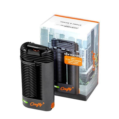 Front view of the Storz & Bickle Crafty Plus Portable Vaporizer, showcasing its sleek, black design against a blurred background.