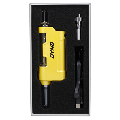 Top-down view of the yellow Yocan Dyno Kit Yellow in foam packaging with its glass mouthpiece, charger cable, and metal accessory.
