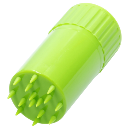 Close-up angled view of a bright lime green Atomik Grind & Stash showing its textured screw cap and spiked grinding surface.