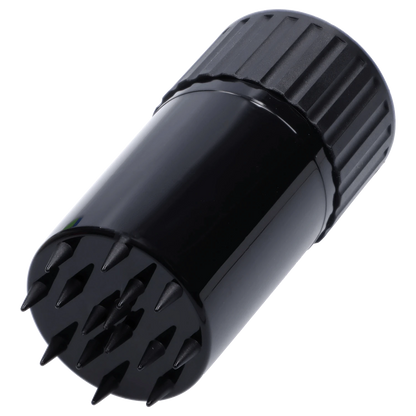 Angled close-up of the black Atomik Grind & Stash showing its ridged twist cap and spiked grinding plate.