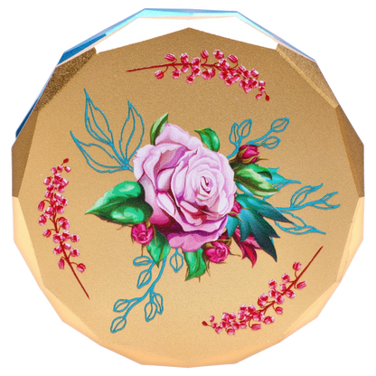 Top-down view of the Famous Design Floral Lush Aluminum 2 Stage Grinder - Teal and Gold showing a painted pink rose and teal leaves on a gold octagonal lid