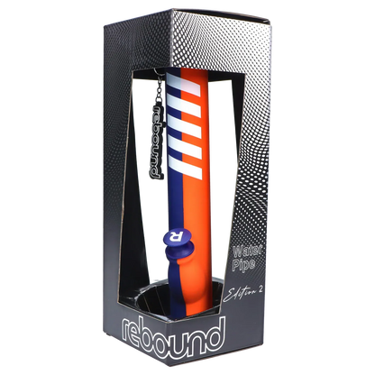Angled front view of the Rebound Edition 2 - Straight - Blue & Orange water pipe shown upright in its black dotted display box with a hanging logo tag.