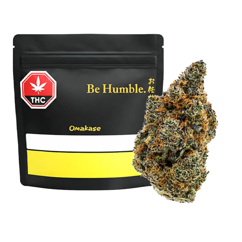 Front view of a black resealable bag labeled "Be Humble. Omakase" beside a close-up of a frosty green and orange bud.