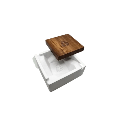A top-down view of the BRN Briq Concrete Ashtray (Marble) on a white surface, showcasing its square shape and textured finish.
