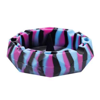 A close-up, angled view of the Valiant Silicone Diamond Ashtray-5in, displaying its faceted design and smooth, dark interior.