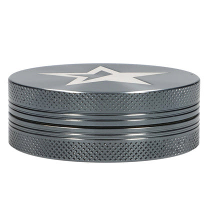 A close-up, angled view of the gray 55mm Famous X Chrome 2 pc Grinder, showcasing its textured, two-piece design.