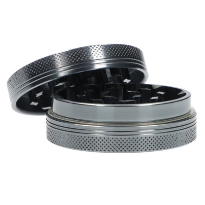 A top-down view of the open Famous X Chrome 2 pc Grinder, revealing its two gray, textured grinding pieces.