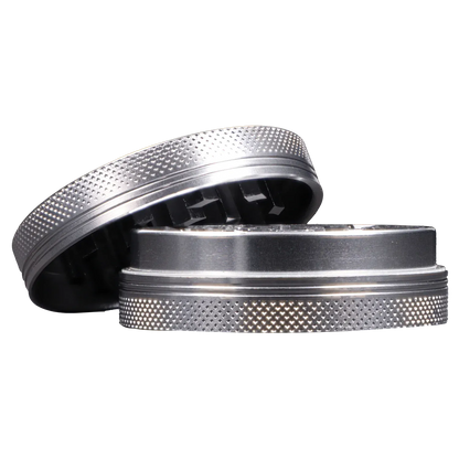 Close-up side view of the Famous X - Crystal 2 pc Grinder-Silver-55mm showing its textured silver top and inner teeth.