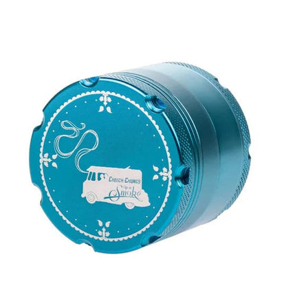 A close-up, angled view of the C&C Up In Smoke Grinder-Aqua, showcasing its metallic aqua finish and multi-tiered design.