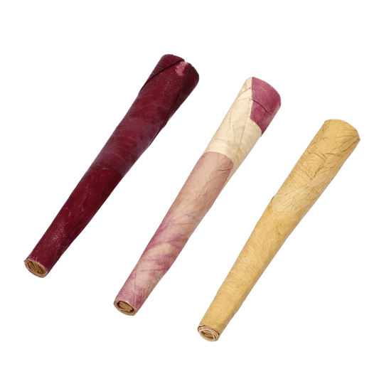 A close-up, angled view of Petals Rose Mini Cones, showing the rolled paper filters in shades of pink and tan.