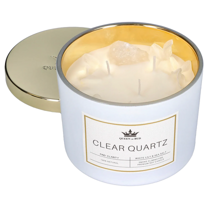Close three-quarter view of the Queen of Bud: Clarity Ritual Box – Candle, Zippo, and Crystal showing a white jar candle with gold interior, visible clear quartz pieces, three wicks, and the gold lid set beside it