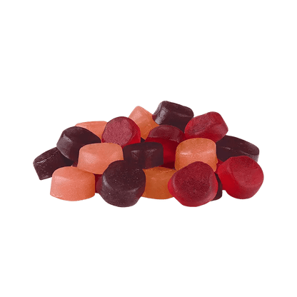 Overhead view of colorful Orchard Medley Gummies scattered against a plain white background.