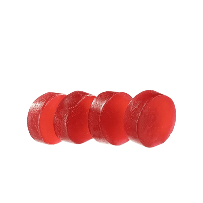 A close-up of the red Sugar Free Raspberry Acai 1:1 Gummies, arranged in a neat, linear formation against a white background.