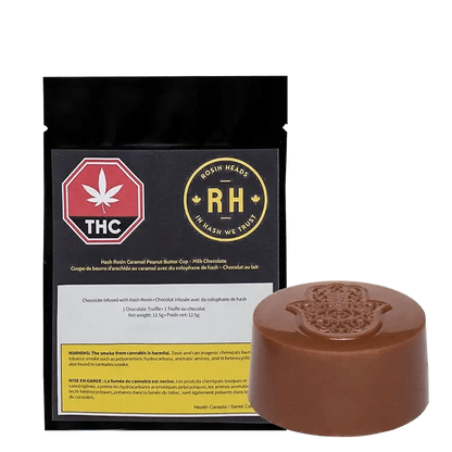 Close-up of the Hash Rosin Caramel Peanut Butter Cup wrapper against a dark background, showcasing the product’s logo and branding.