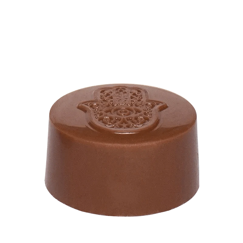 A close-up, top-down view of the Hash Rosin Caramel Peanut Butter Cup, showcasing its rounded, chocolatey form.