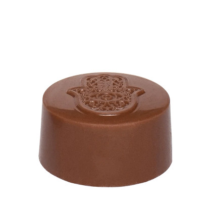 A close-up, top-down view of the Hash Rosin Caramel Peanut Butter Cup, showcasing its rounded, chocolatey form.