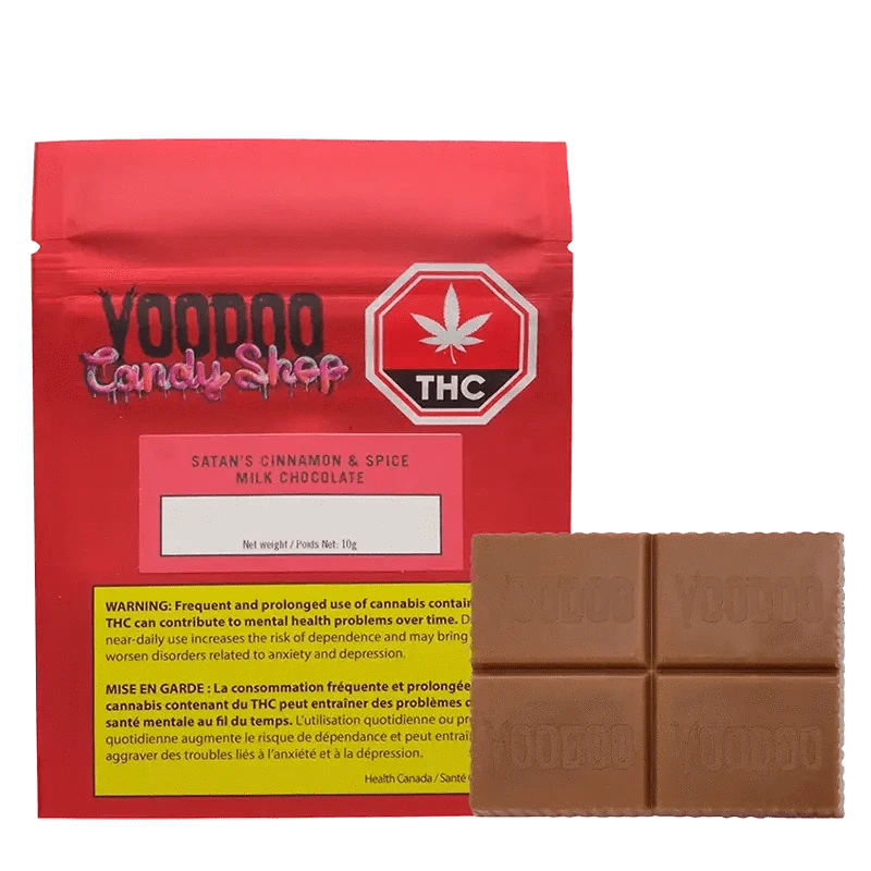 Front view of the Vomno Cinnamon & Spice chocolate bar packaging, displaying a warning label with a dark background.