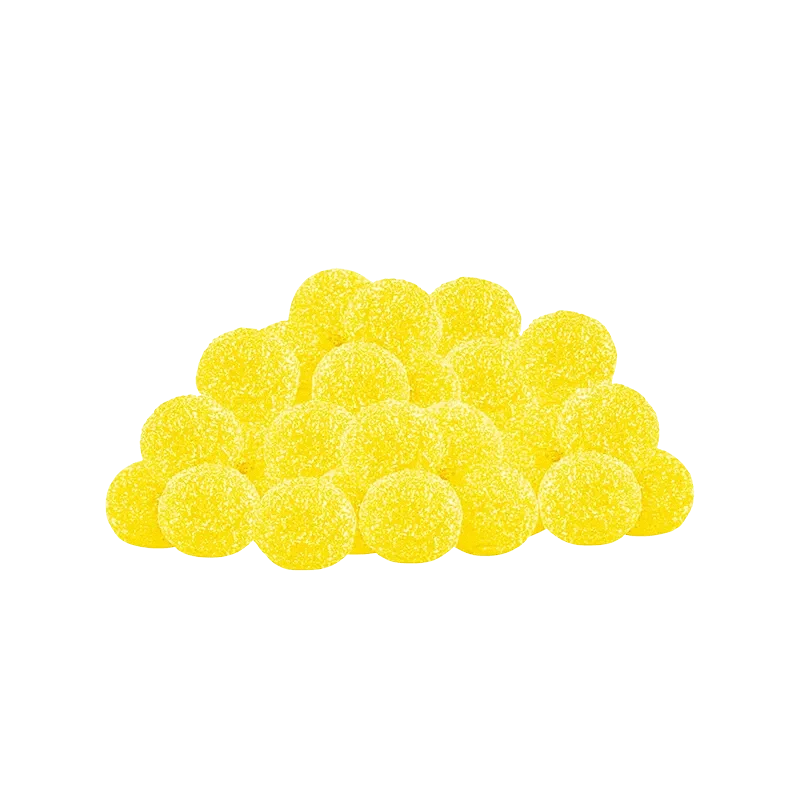 A close-up, top-down view of Lemon Dream CBN Gummies, displaying a pile of golden-yellow, round candies.