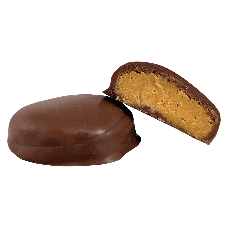 Close-up view of the Peanut Butter Bite with a broken piece revealing its creamy filling.