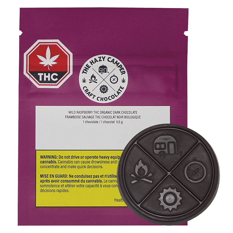 Close-up of Wild Raspberry Thc Organic Dark Chocolate packaging with a dark background and a prominent cannabis leaf logo.