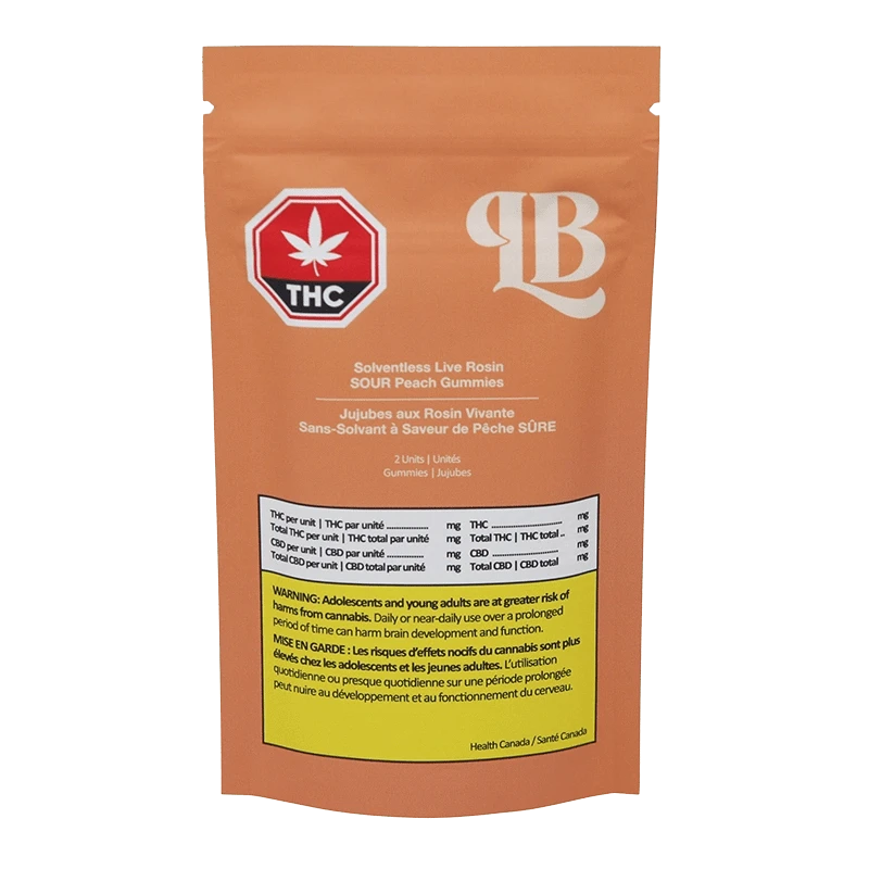 Close-up of Solventless Live Rosin Sour Peach Gummies packaging with a warning message in French, angled slightly to the left.